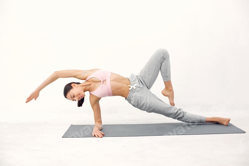 A beautiful girl is engaged in a yoga studio