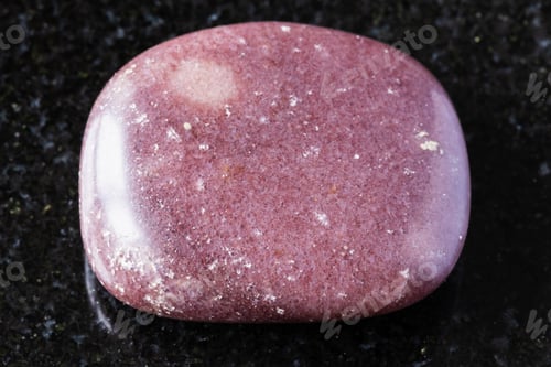 Preview: polished red brown quartzite rock on black