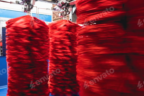 Preview: detail of automatic car wash system with red cleaning brushes rotating with motion blur