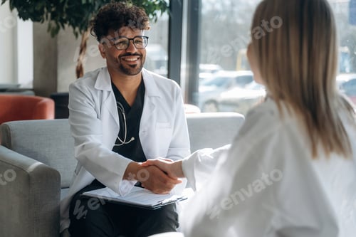 Preview: Consultation with doctor. Man and woman are indoors in modern building