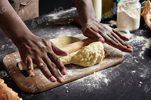 Preview: Cropped shot of man`s hands sheets dough with rolling pin indoor bakes delicious cakes or pastry, pr