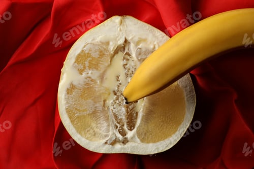 Preview: Banana on pomelo fruit with condensed milk on red cloth background
