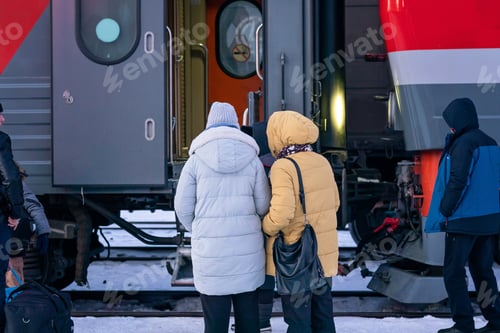 Preview: two women stand on the platform at the entrance to the train car