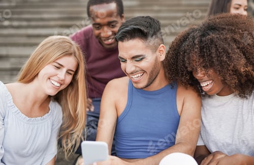 Preview: Multiracial young friends using mobile phone in the city - Diverse people having fun outdoor