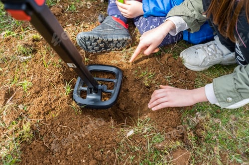 Preview: Kids treasure hunters metal detecting and digging the ground