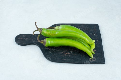 Preview: Green chili peppers on dark board