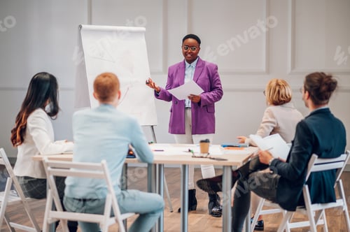 Preview: African american businesswoman holding a presentation during a meeting in an office