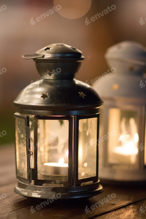 Preview: Lanterns on a wood table on an outdoors wedding banquet