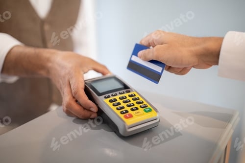 Preview: Customer Man Swiping Credit Card Paying Via Terminal Indoor, Closeup