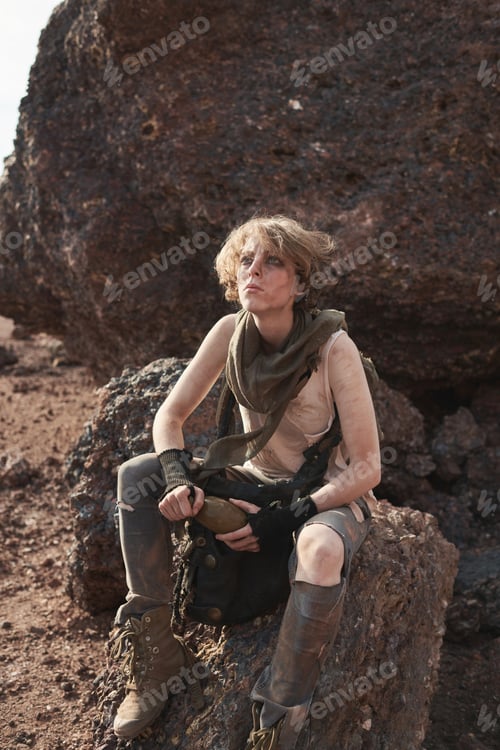 Preview: Woman sitting on the rock outdoors