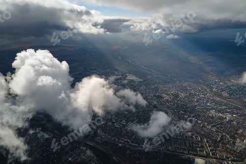 Preview: Aerial view from airplane window at high altitude of distant city