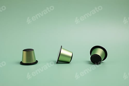 Preview: Disposable coffee capsules over green background with copy space. Morning dose of caffeine, energy