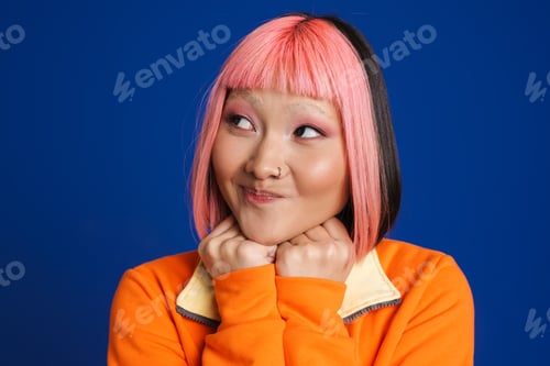 Preview: Asian girl with pink hair and piercing looking aside