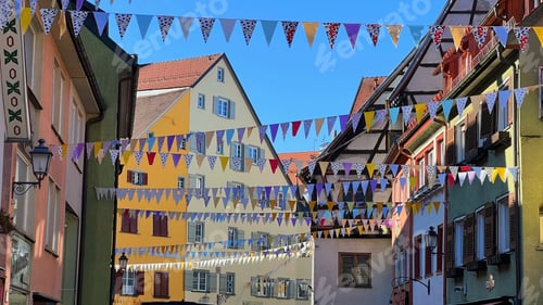 Preview: Vibrant scene of colorful array of flags lined along the street