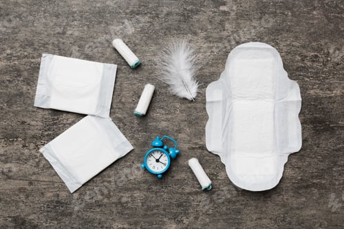 Preview: Ringing alarm clock with sanitary female tampons and menstrual sanitary pads.