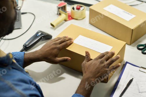 Preview: Engineer putting sticker on top of box
