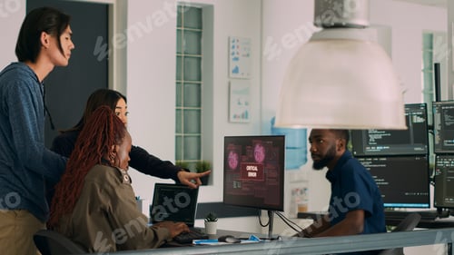 Preview: Multiethnic group of developers encountering system crash and hacking alert