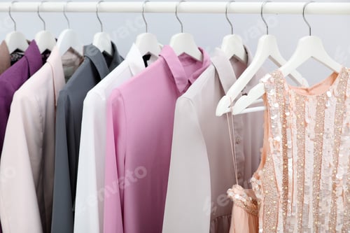 Preview: Rack with stylish clothes on light background, closeup