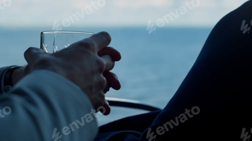 Preview: Businessman hands holding whiskey in ocean window closeup. Boss holding glass
