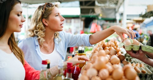 Preview: Young women shopping on the market healthy vegetables and fruits