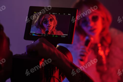 Preview: Filming Monitor Showing Woman with Microphone Singing