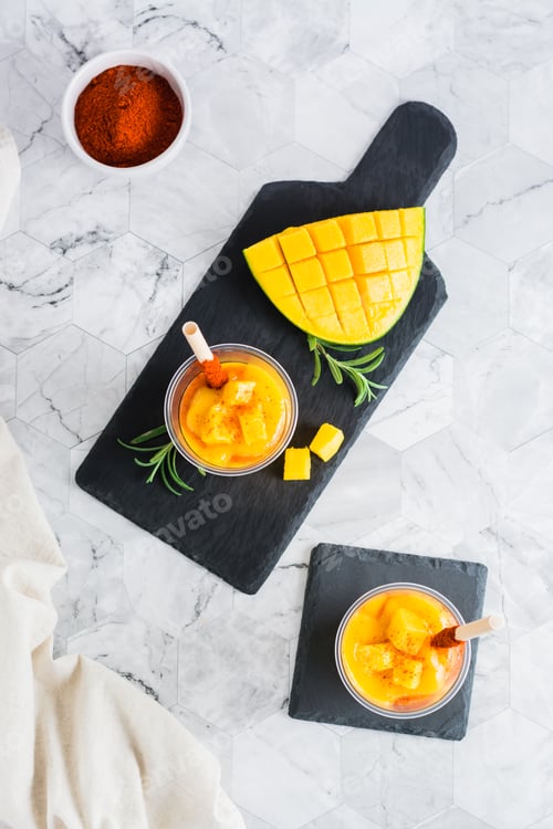 Preview: Mangonada mexican smoothie from mango with chamoy sauce and tamarind straw in plastic cups
