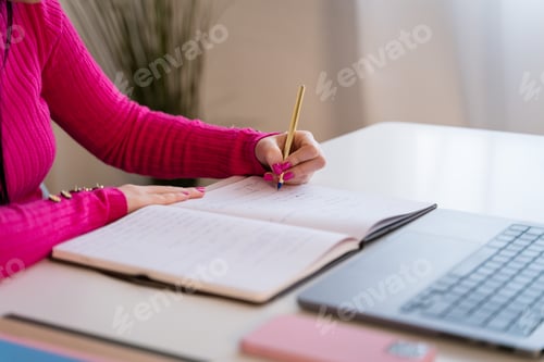 Preview: Crop anonymous female student doing homeworks