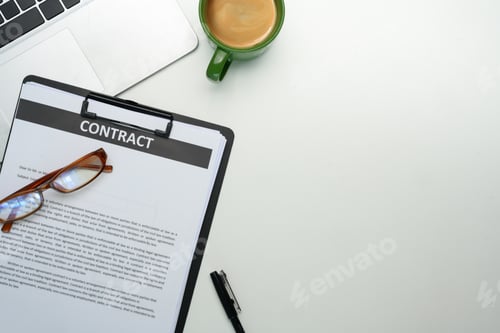 Preview: Close up of contract on clipboard, glasses, a cup of coffee and laptop on organized workspace