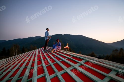 Preview: Man and woman enjoy beautiful sunset in the mountains