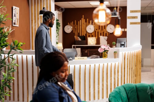 Preview: Man waiting for receptionist in hotel