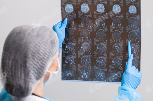 Preview: Beautiful female radiologist looking at the MRI scan images