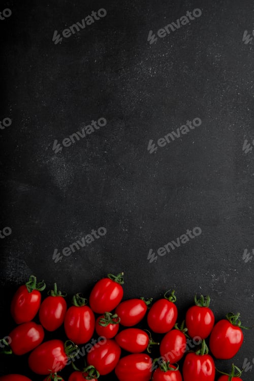 Preview: top view of small tomatoes on black background with copy space