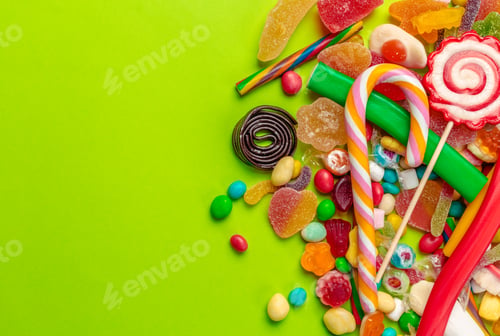 Preview: Colorful candies on green background