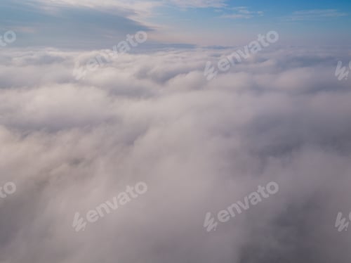 Preview: A drone flies over fluffy clouds. The drone flies through the clouds, creating a sense of wonder