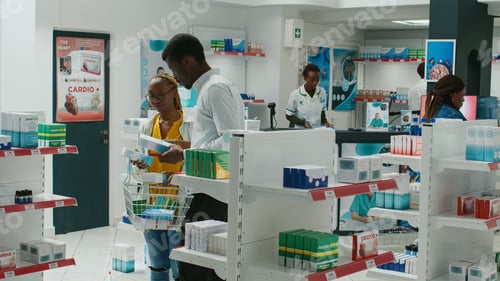 Preview: Young people looking for vitamins at medical shop