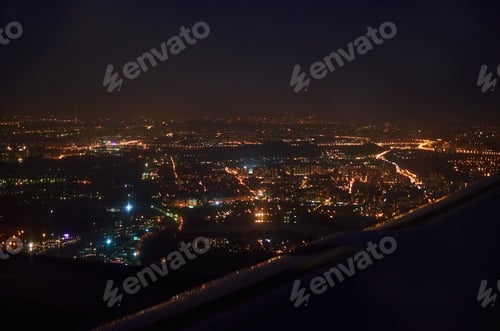 Preview: view from the window of the plane on the night city. bird's eye view of city lights at night