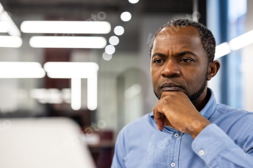 Preview: Focused African American office worker deep in thought at workplace