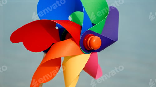 Preview: Rotating pinwheel on a sandy beach, symbolizing the joy of travel, beach tourism