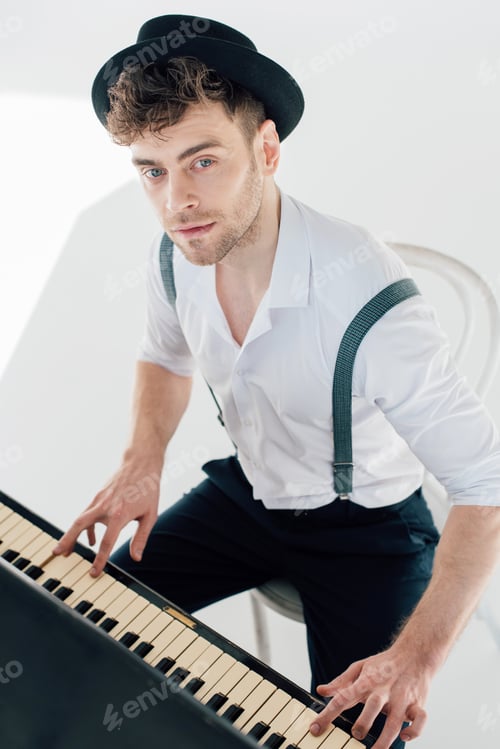 Preview: dreamy pianist in white shirt and black hat playing piano