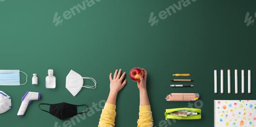 Preview: Flat lay top view of face mask and school supplies, back to school and coronavirus concept.