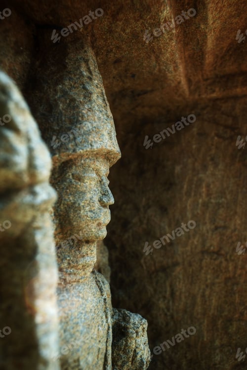 Preview: Closeup shot of an old person's sculpture built in an ancient building