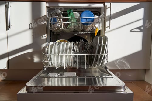Preview: Front view of dishes and utensils in a dishwasher in Spain