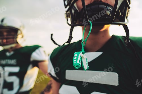 Preview: Young American football player with his mouthguard out during practice