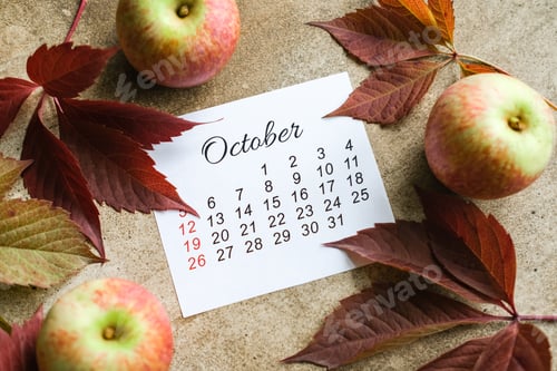 Preview: October calendar on brown background, surrounded by ripe apples and dark red autumn leaves