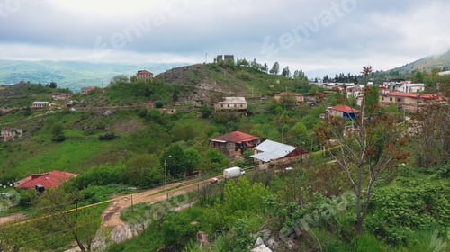 Preview: Hillside village in Nagorno Karabakh showcasing traditional homes and lush greenery