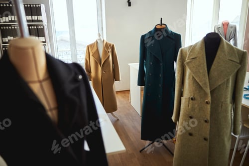 Preview: Vacant room filled with mannequins in coats