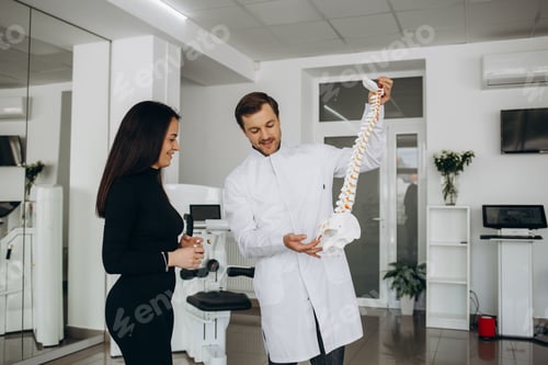 Preview: Experienced vertebrologist explaining the spine anatomy basics to a patient.