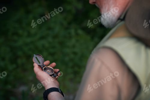 Preview: Tourist Using Compass While Hiking