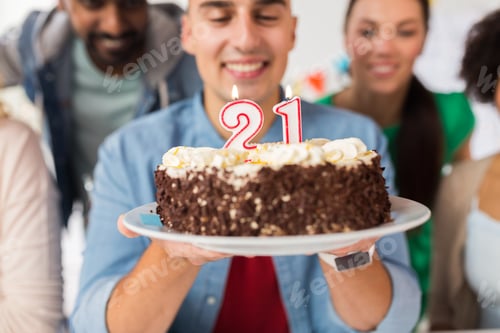 Preview: man with cake and friends at birthday party