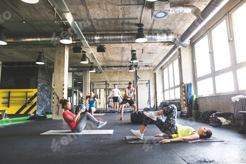 Preview: Group of young people exercising in gym